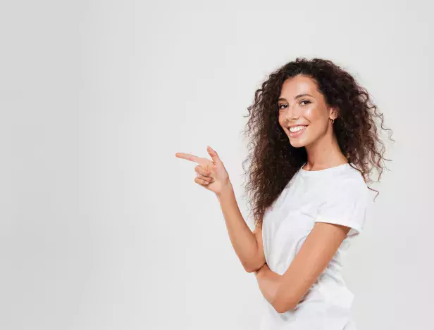 side-view-of-smiling-curly-woman-pointing-away-1-0